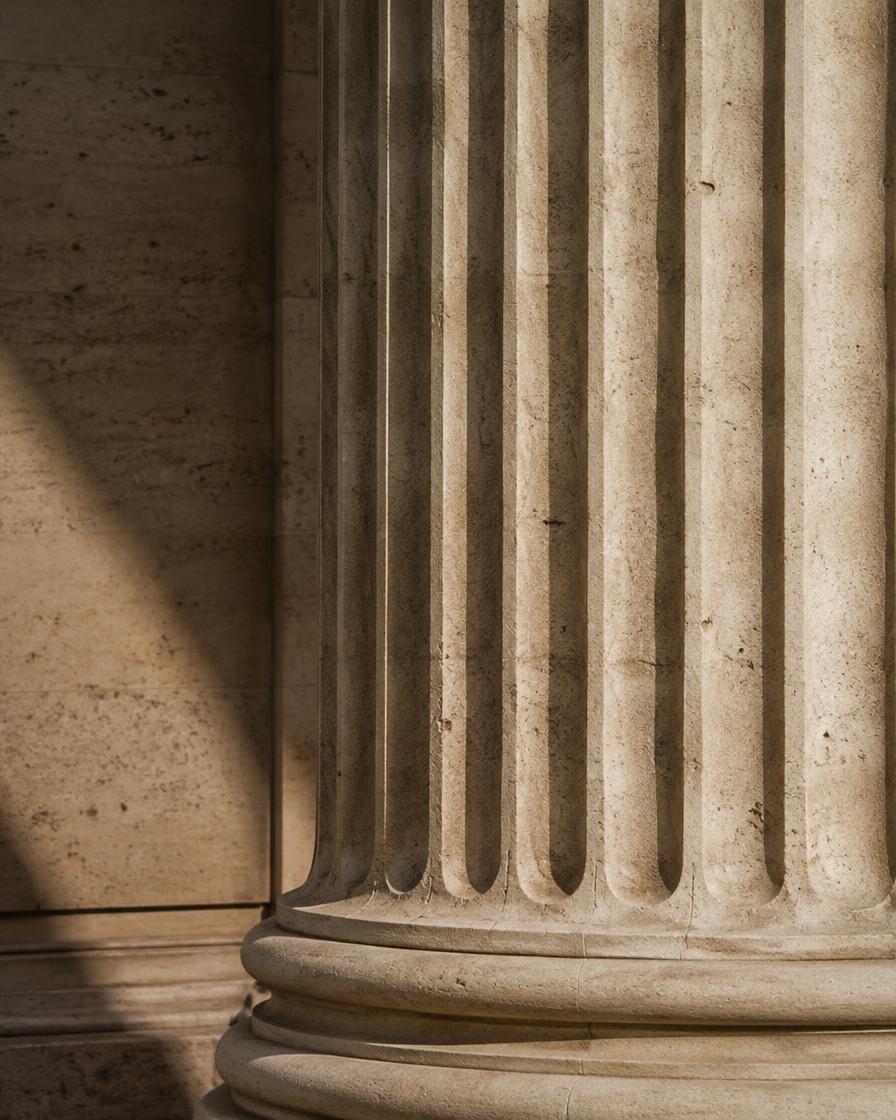 Fluted travertine column in raking light